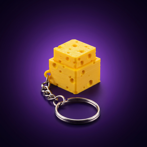Llavero fidget de queso clicker, foto de estudio fondo morado
